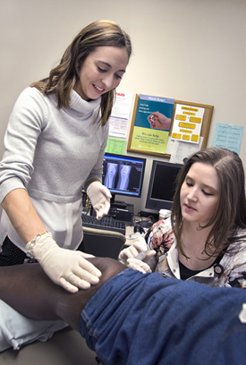 Barker with patient and student