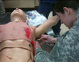 Kritsin Pfeiffer - A family medicine resident at MAMC practices techniques on a mannequin.