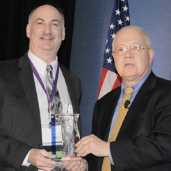 Dr. Robert A. Petzel (right), presents Dr. David Gaba with the 2011 Excellence in Clinical Simulation Training, Education and Research Practice Award