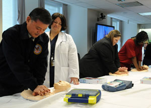 Secretary of Veterans Affairs Eric K. Shinseki (left) practices CPR compressions during Resuscitation Education Initiative (REdI) training at the VA Central Office 