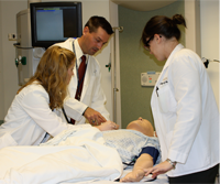 Secretary of Veterans Affairs Eric K. Shinseki (left) practices CPR compressions during Resuscitation Education Initiative (REdI) training at the VA Central Office