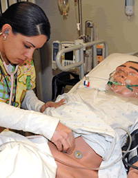 medical student practicing on a mannequin.